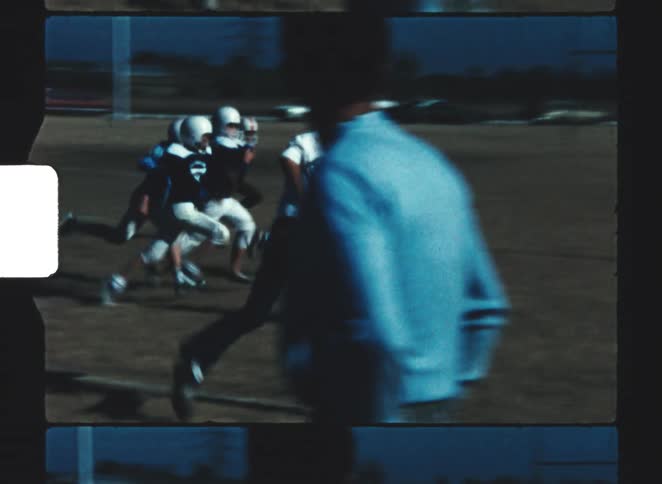 The children rush on the field while playing football