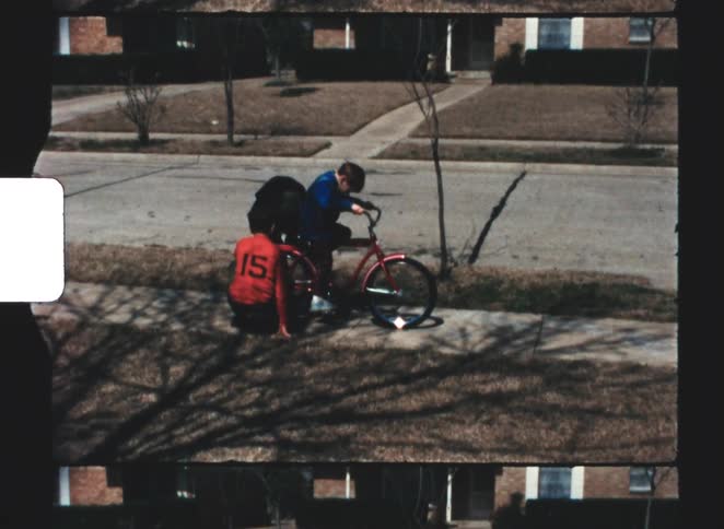 Children are repairing a bike on the sidewalk
