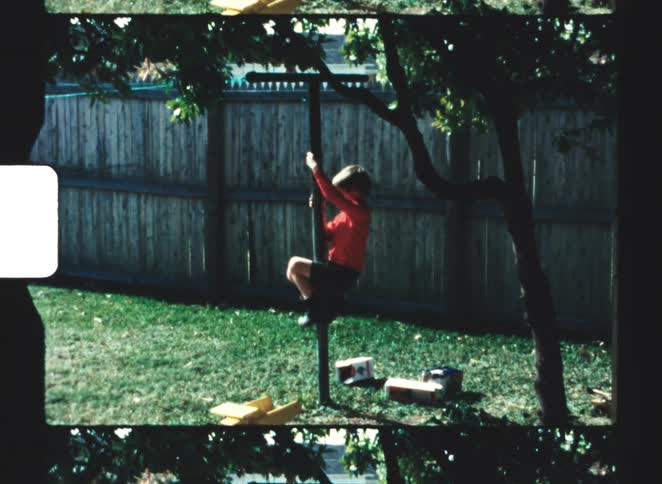 A child climbs up a pole