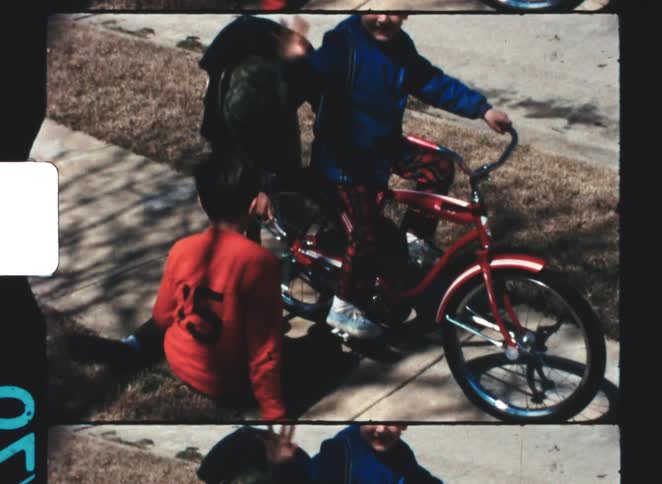 The boy is repairing the bicycle with a wrench