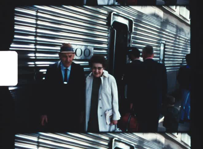 People exit and enter the passenger train