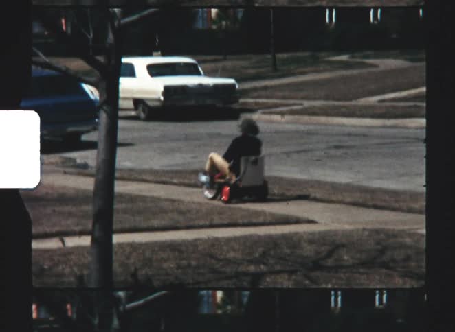 A child drivnig a pedal car