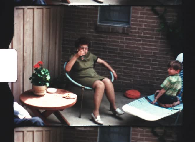 A family sits in chairs on the patio