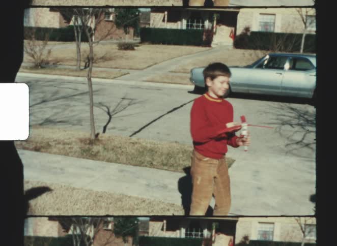 The child turns and walks on the sidewalk