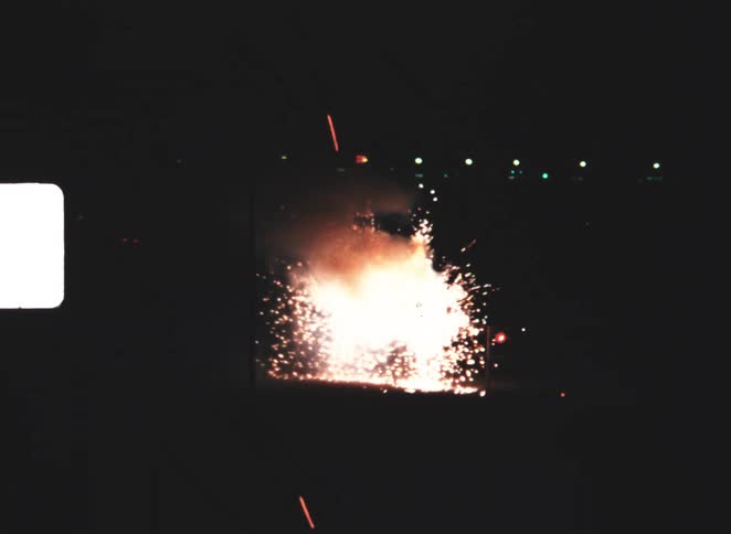 Fireworks explode on the ground and shoot sparks into the sky