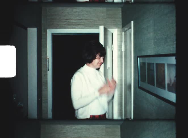The woman enters the home and covers her face from embarrassment