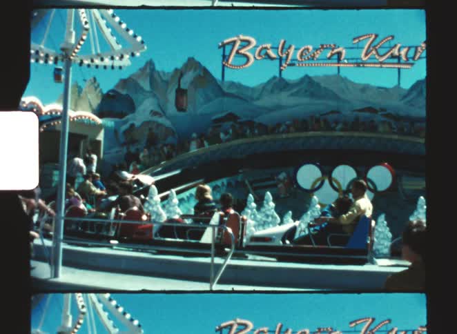 Group of people on a fastpaced circular bobsledstyle ride that comes to a standstill due to a technical issue