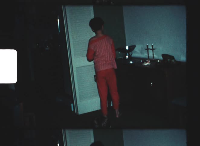 The boy searches around the room