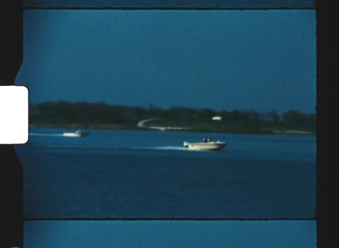 Speedboats traveling at high speed across a large lake