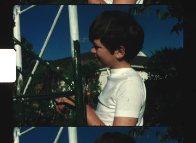 A child painting a seal with black paint changing its white appearance under a sunny day