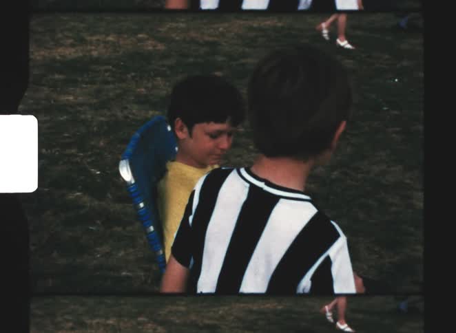 Two boys talk together outside