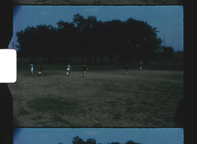 The woman jumps up and down while watching the soccer game
