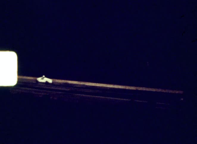 Roller skate tracks stretch across the darkness forming parallel lines