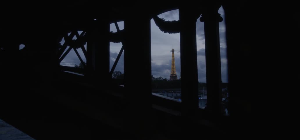 Person walking up a dark structure on a cloudy night