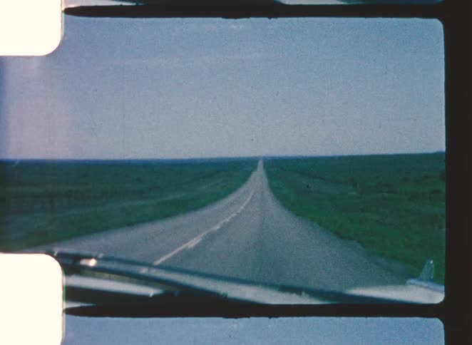 A view of a car driving down a road