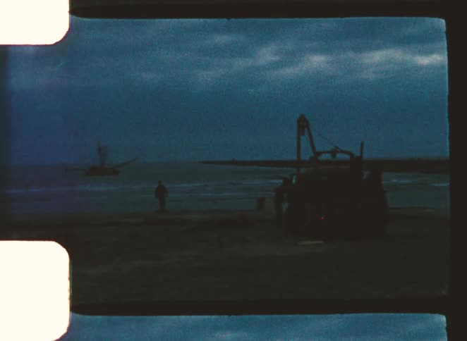 A large truck is parked on the beach
