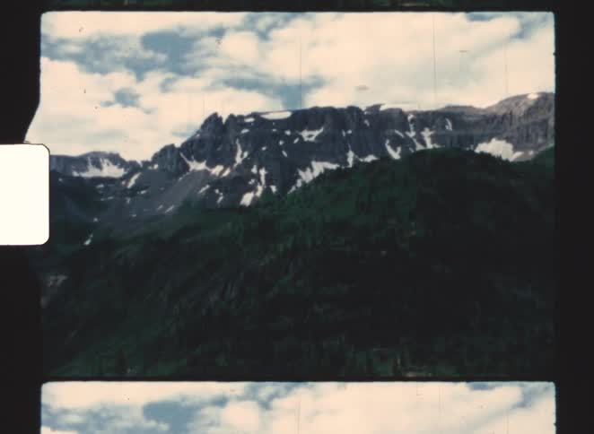 A view of some mountains with snow on their caps