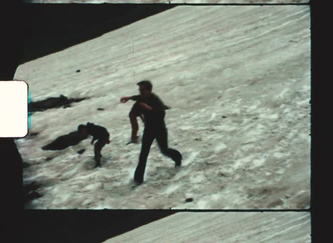 People walking on a snowcovered slope with a steep incline