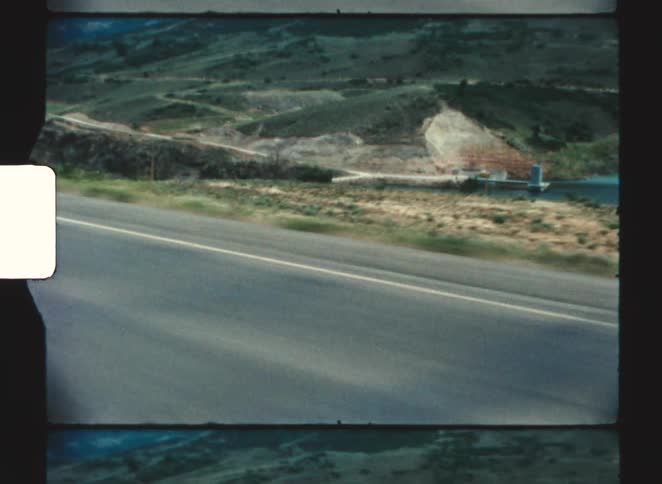 Driving past a low valley with hills