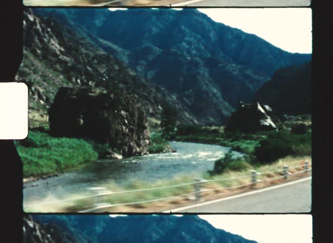 Riding past a river and some mountains
