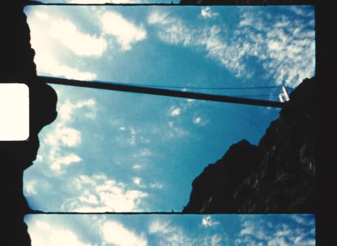 royal gorge 1970 Cable stretched between rocky formations seen against a blue sky with scattered clouds