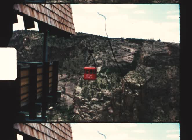 Red cable car crossing a mountainous canyon with the inscription royal gorge