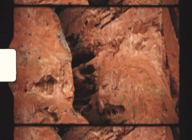 Reddish rock formations with visible layers and erosion patterns