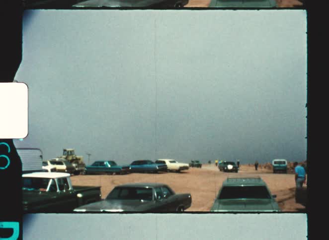 pikes peak colorado springs 1970 Open area with parked cars and people moving around under an overcast sky