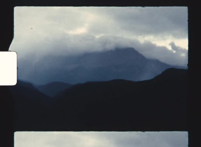 A view of mountains and clouds in the distance