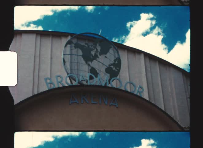 Sculpture of a globe stands behind the sign for the broadmoor arena on a cloudy day