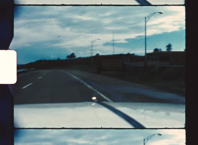 The white car drives on the highway