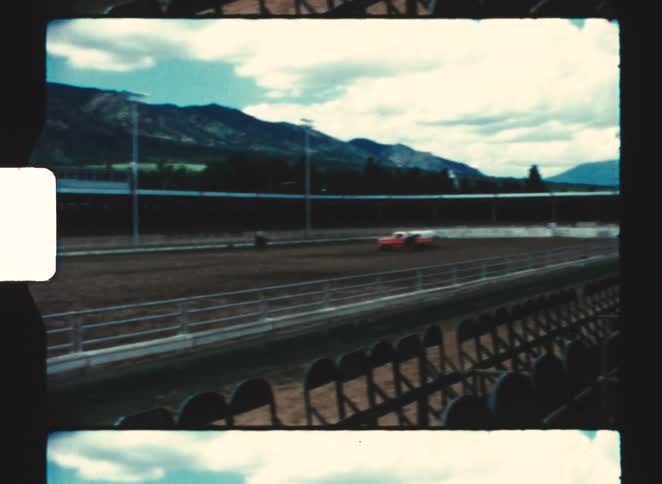 A stadium with a track field and empty seats at midday