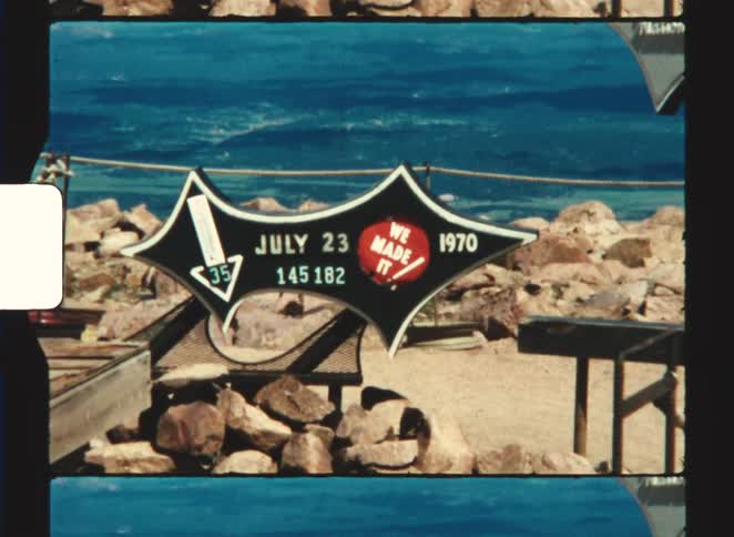 pikes peak Shaky vintage footage focuses on a black summit sign dated july 23 1970 adorned with a we made it sticker before cutting to a wide view of the windswept barren mountaintop high above the clouds