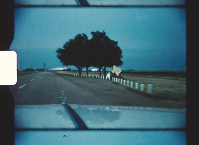View of fields from a moving car