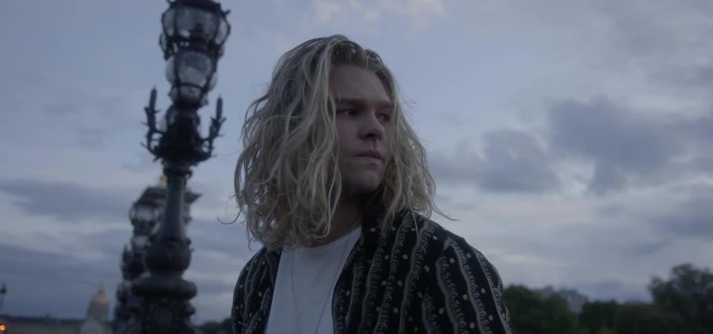 A man looks around on a cloudy day
