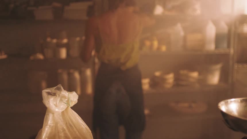 Woman picking up a roll of wrapping ribbon