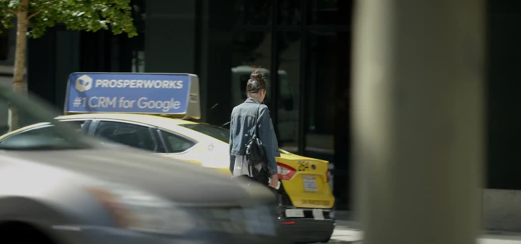 A woman walks across the busy intersection in a city