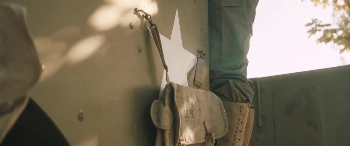 A white star drawn on the body of a vehicle with a bag in front