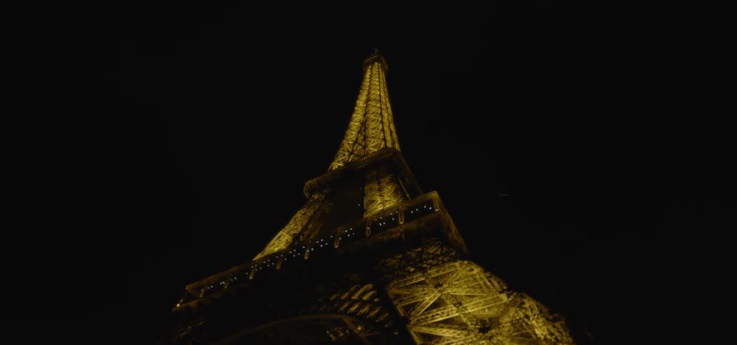 The eiffel tower illuminates the dark night sky