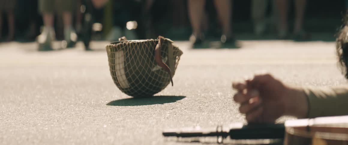 Fallen hand beside rifle and helmet