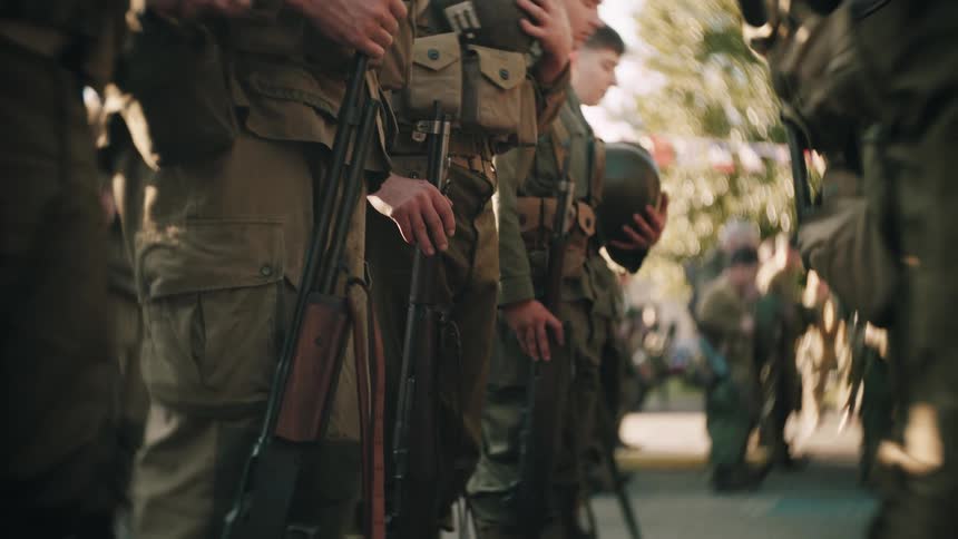 Soldiers lined up with tactical gear during outdoor ceremony