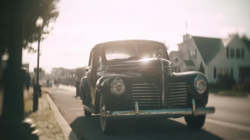 A view of a car sitting on a road