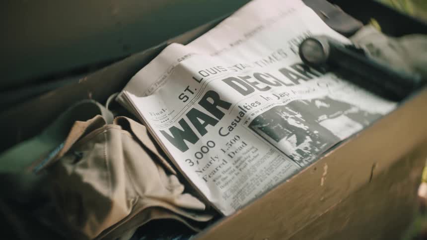 Newspaper and other items fill a box on a sunny day