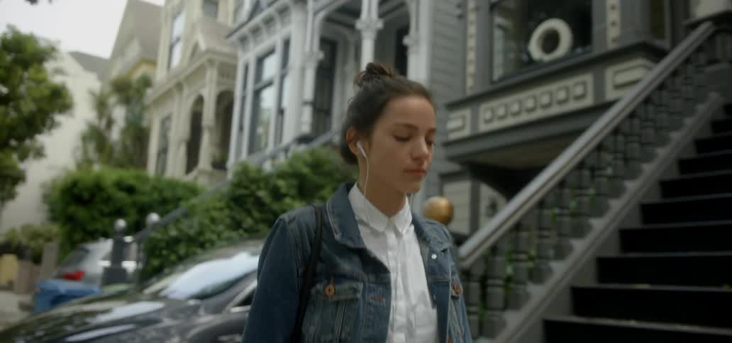 A woman is walking and smiling