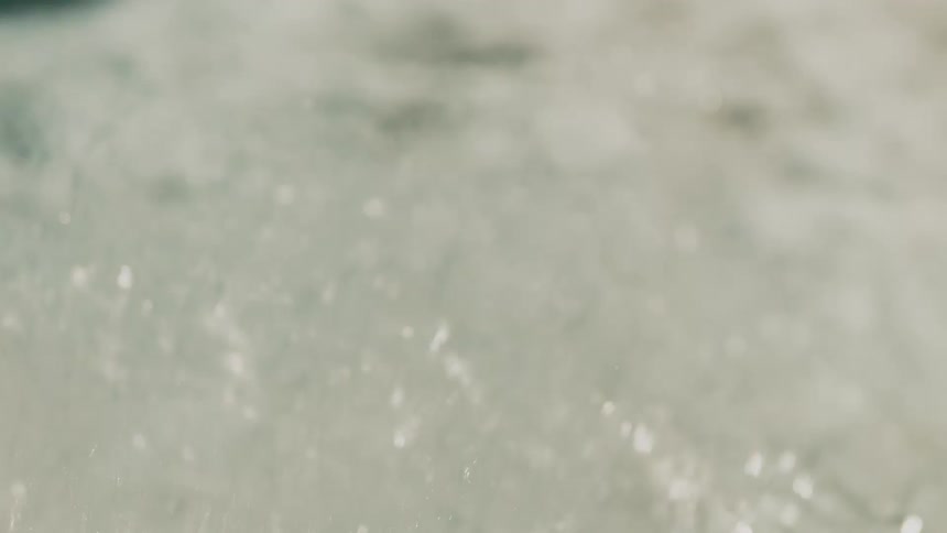 The water flows and crashes on the beach