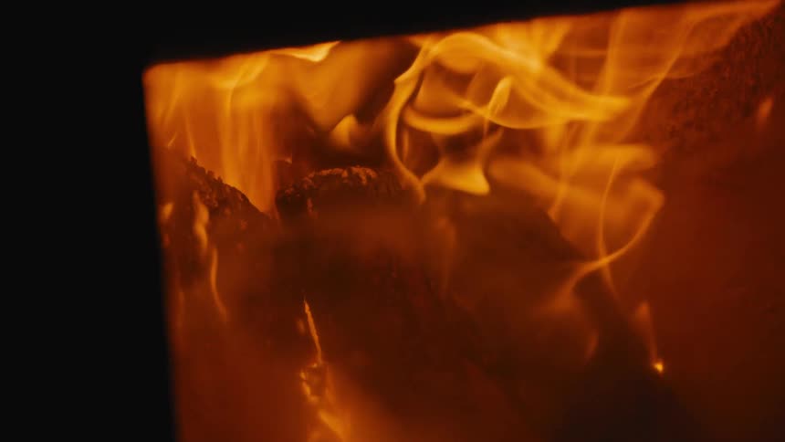 Intense flames consume wood inside heated metal structure