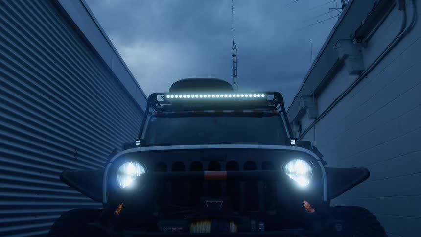 The vehicle is parked in the alley by the buildings
