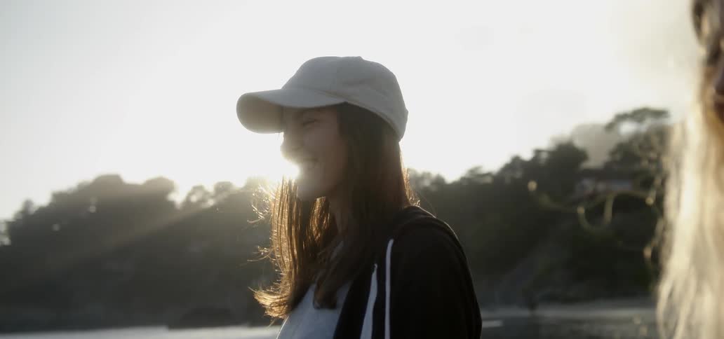 The sun shines behind smiling women