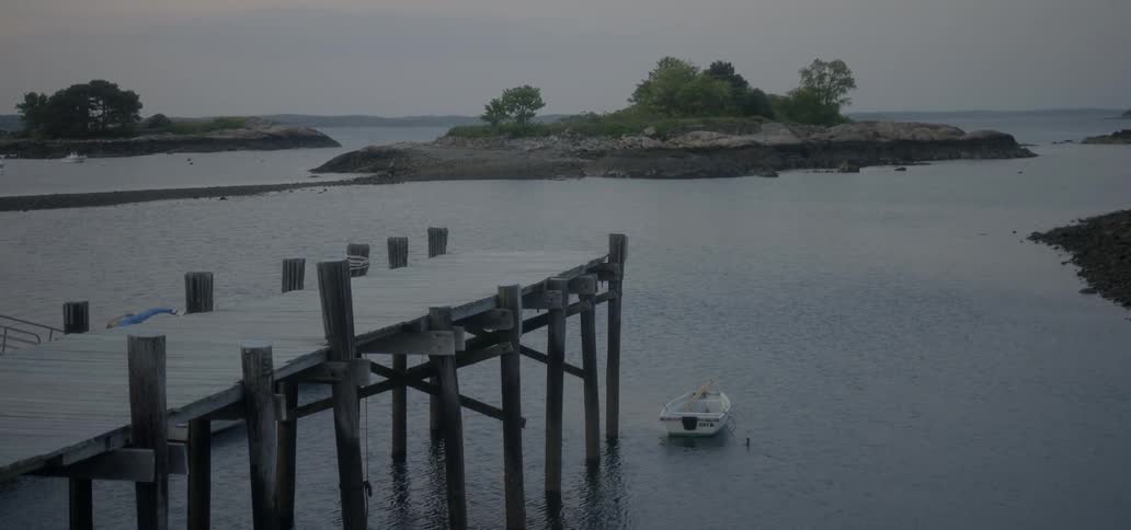 Boat floating in the water near a dock