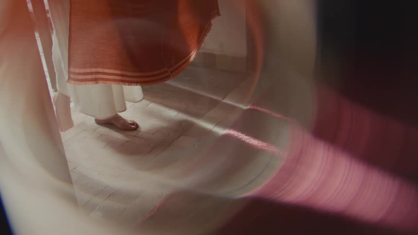 The woman walks through the entryway